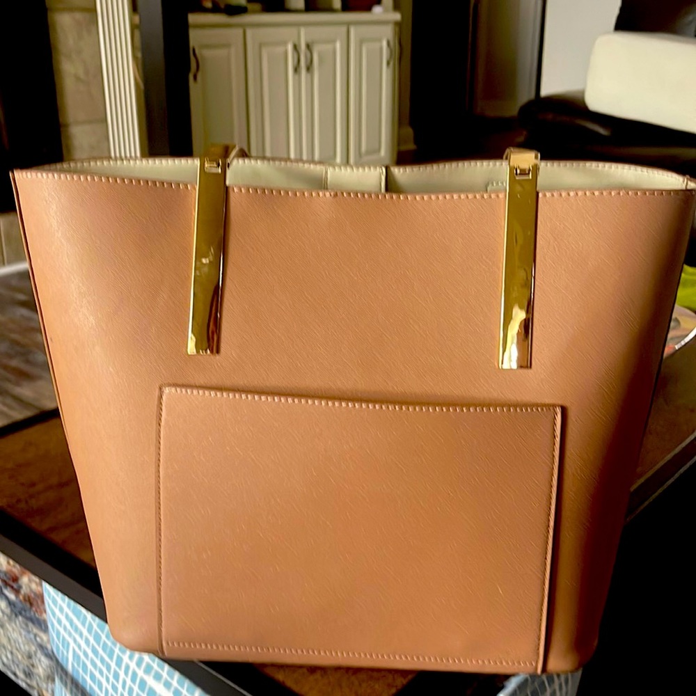 The true color is more peach.  Roomy bag. Great travel